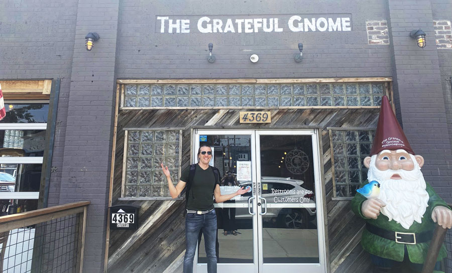Travel Lemming founder, Nate posing for a photo at the entrance of The Grateful Gnome Sandwich Shoppe & Brewery