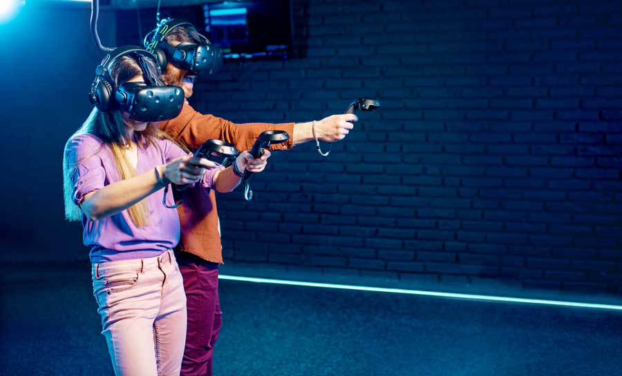 A man and woman playing a VR in a room