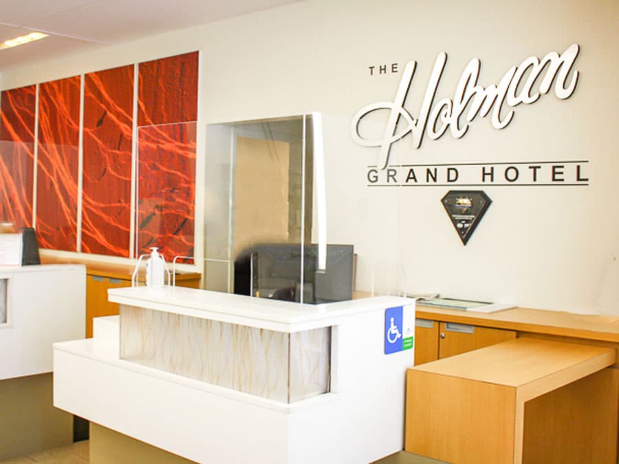 The reception desk of The Holman Grand Hotel