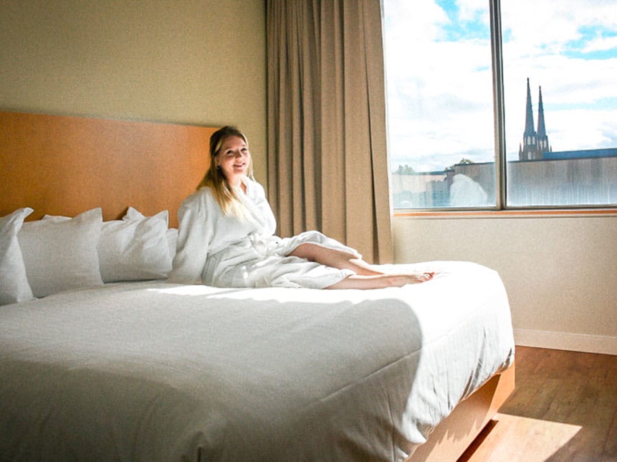 The author on bed in The Holman Grand Hotel