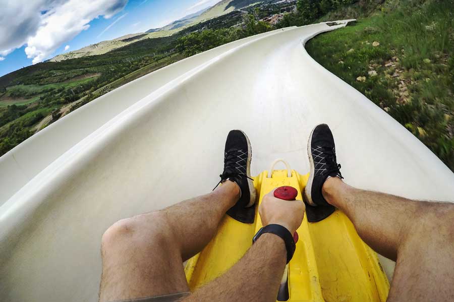 View of a man sliding down a slide in Steamboat Springs