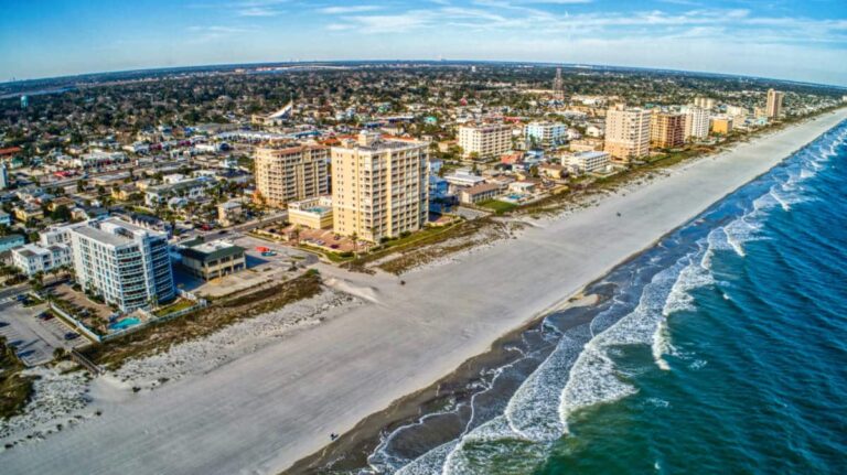 Aerial view of the buildings and the turquoise water at the Jacksonville Beach