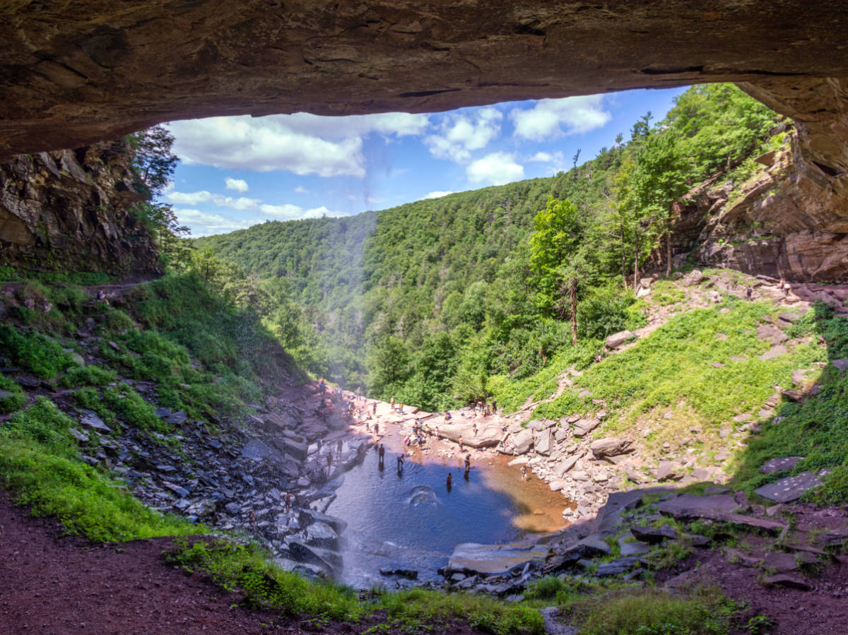 Cave view of Kaaterskill Falls, people enjoying the waterfall