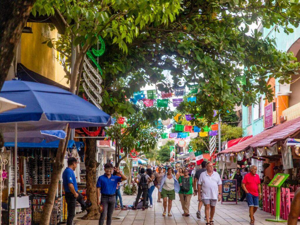 Tourists walking on the commercial street looking at the shops