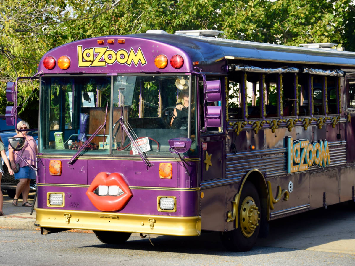 View of the LaZoom purple bus with a mouth decor on its front