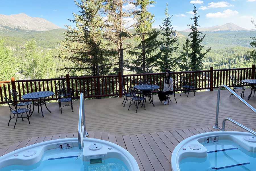 Clara in The Lodge of Breckenridge and the mountain view on her background