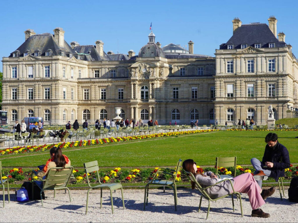 People relaxing on a sunny day in the Paris Luxembourg Garden