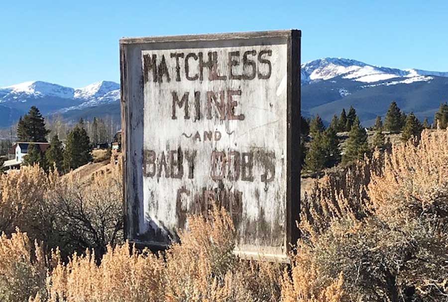 The Matchless Mine sign on a grass area in Leadville
