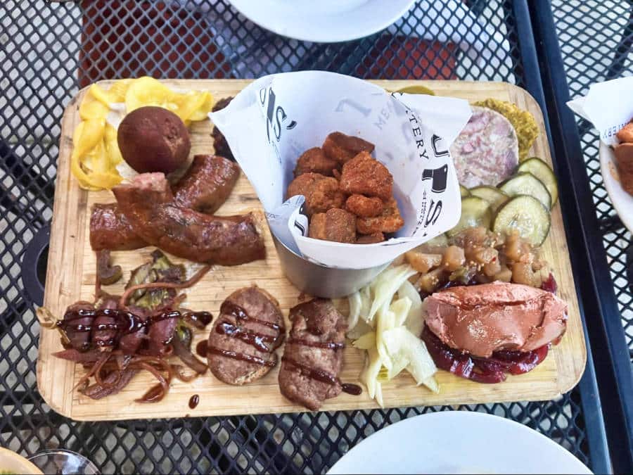 A wooden board with variety of meat variety and vegetable