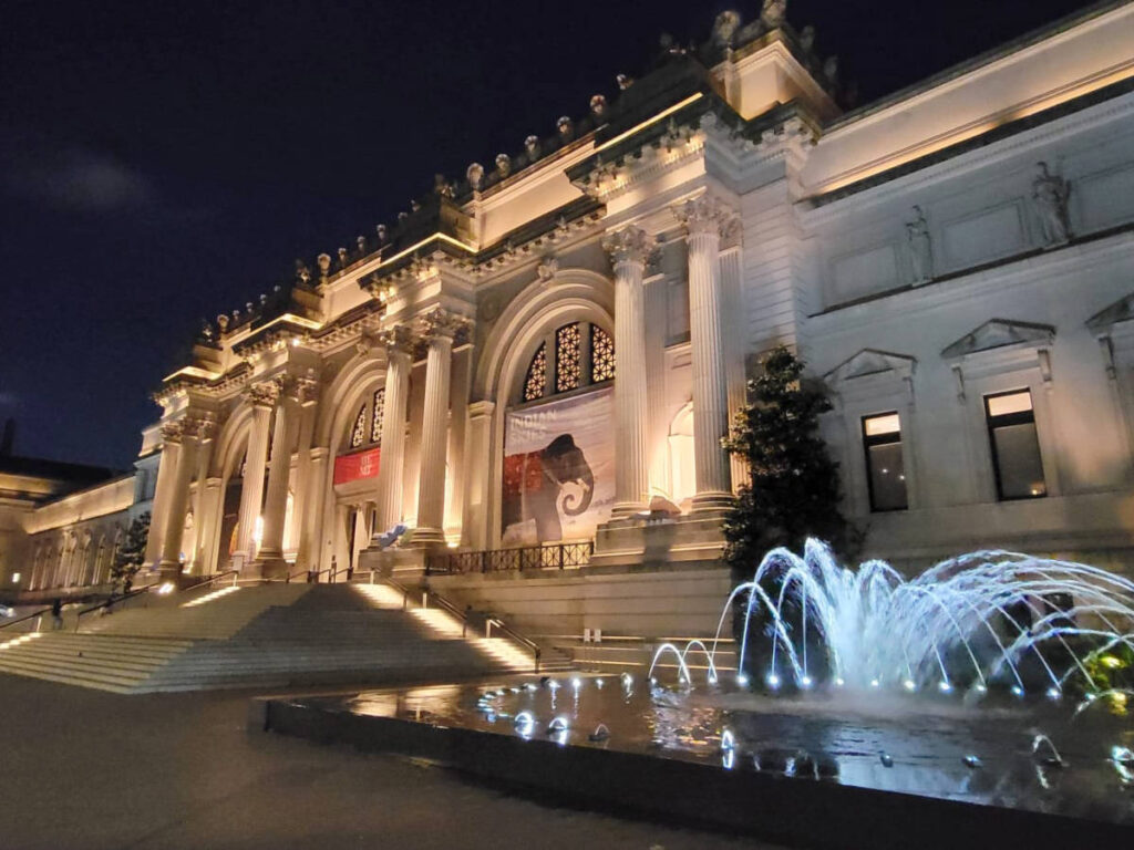 View of the fountain and exterior of The Metropolitan Museum of Art at night