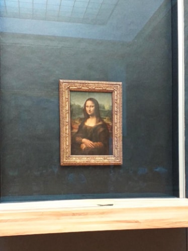 The Mona Lisa painting displayed in Louvre Museum