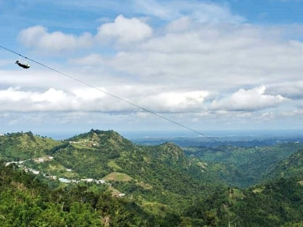 A tourist riding The Monster Zipline at Toro Verde Adventure Park