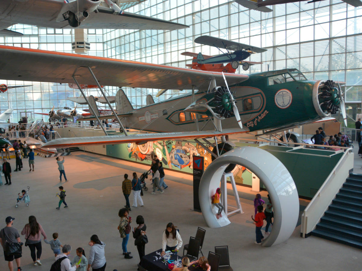Indoor view of the exhibition in The Museum of Flight in Seattle with tourists gathered