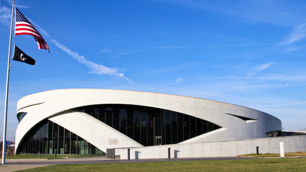 View of the architectural structure of the National Veterans Memorial and Museum and the USA flag on the pole outside