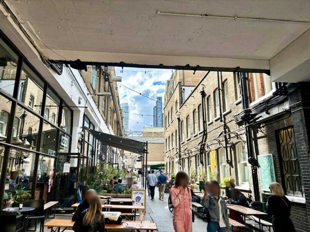 People drinking at the alfresco in The Old Truman Brewery