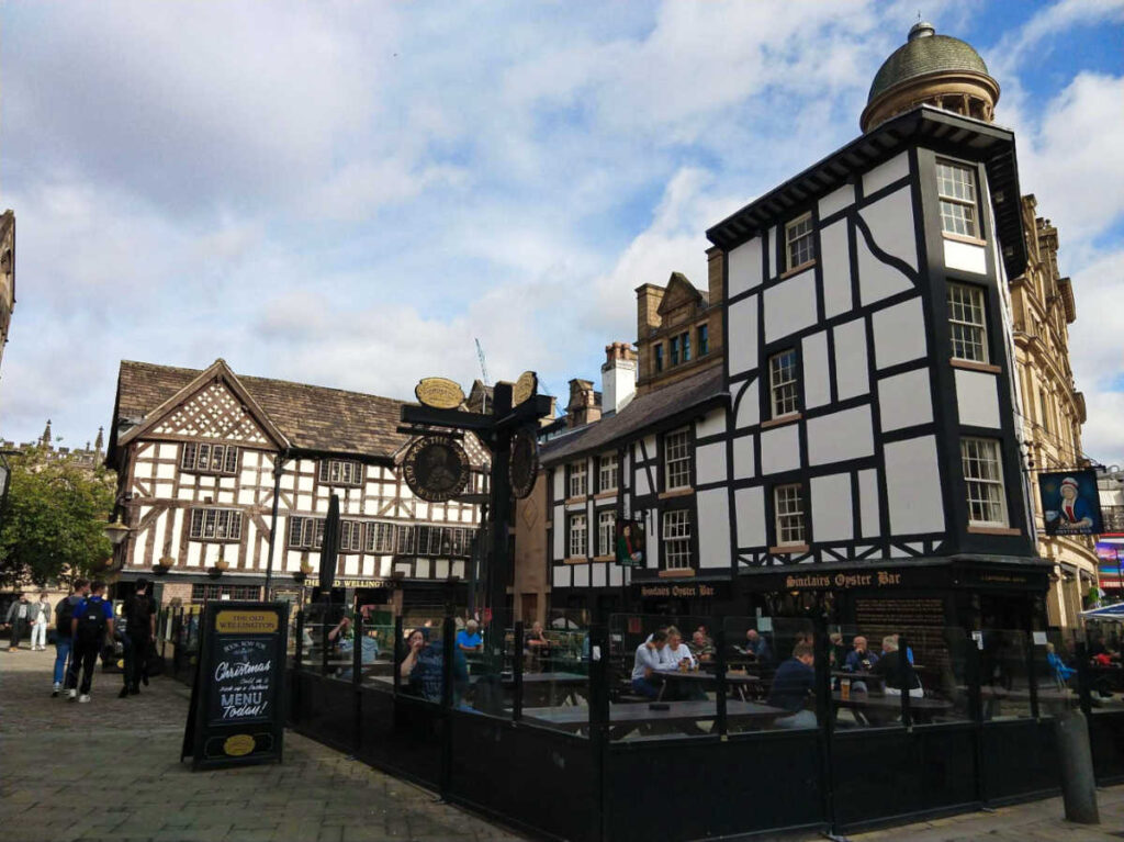 People drinking and dining at the outdoor restaurant in The Old Wellington