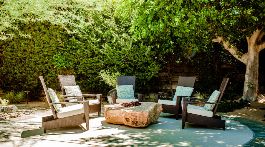 View of the backyard with fireplace, and seating area in The Pillars
