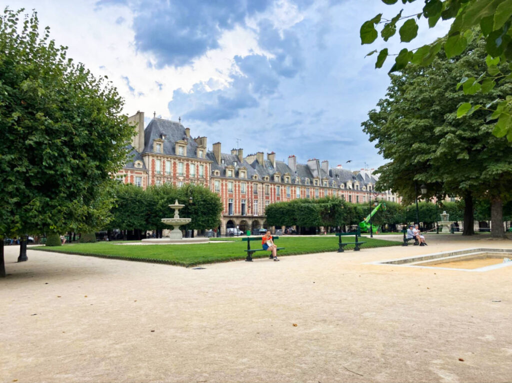 Exterior view of the magnificent Place des Vosges surrounded by greenery