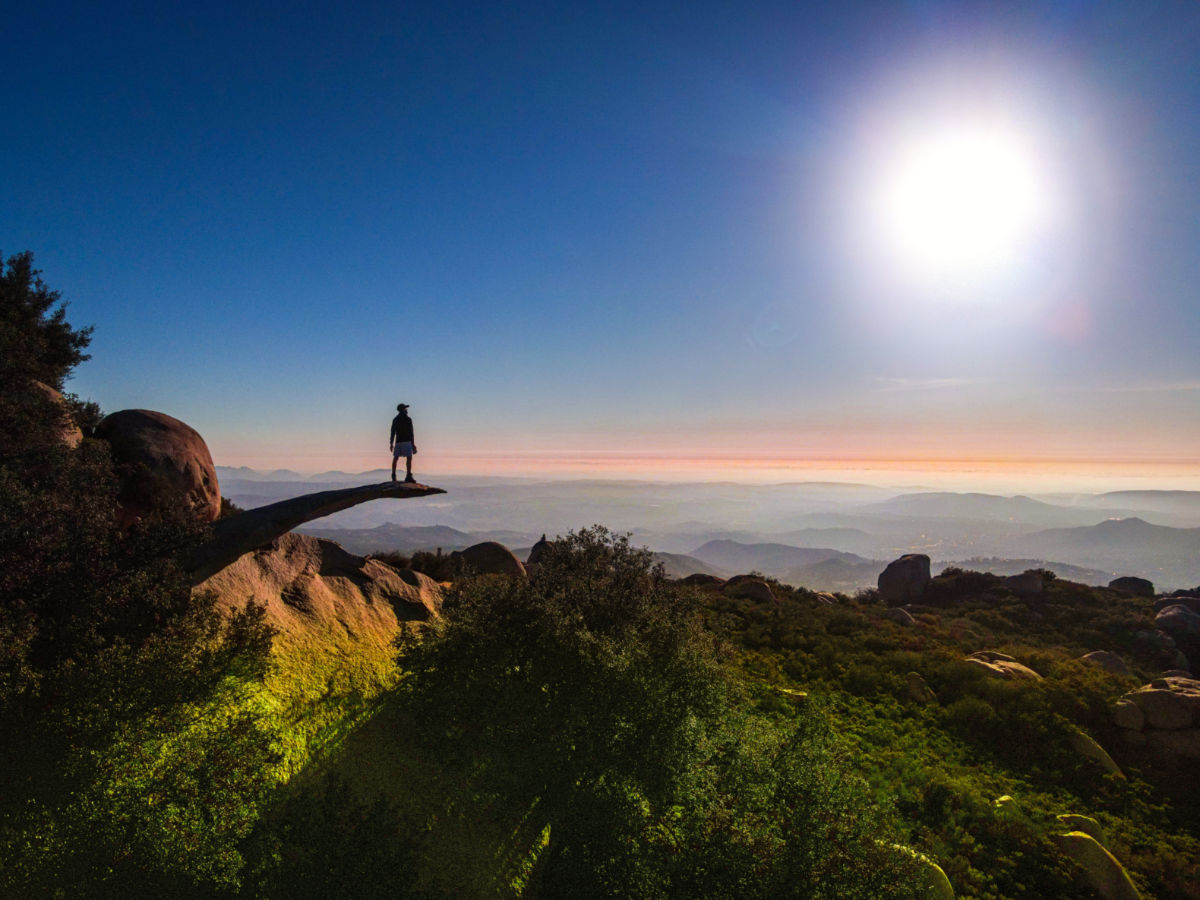 A person standing on top of The Potato Chip Rock