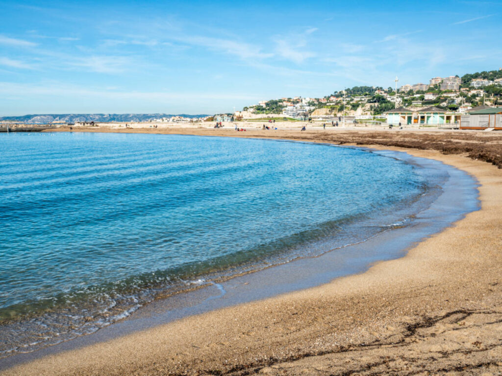 View of the town and the calm blue water from the shoreline of Prado Beach