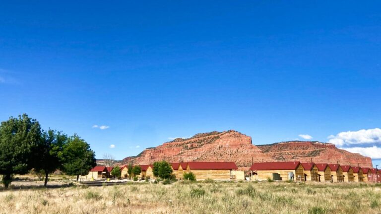 View of The Red Canyon Cabins accommodation with a clear blue sky in the background in Kanab