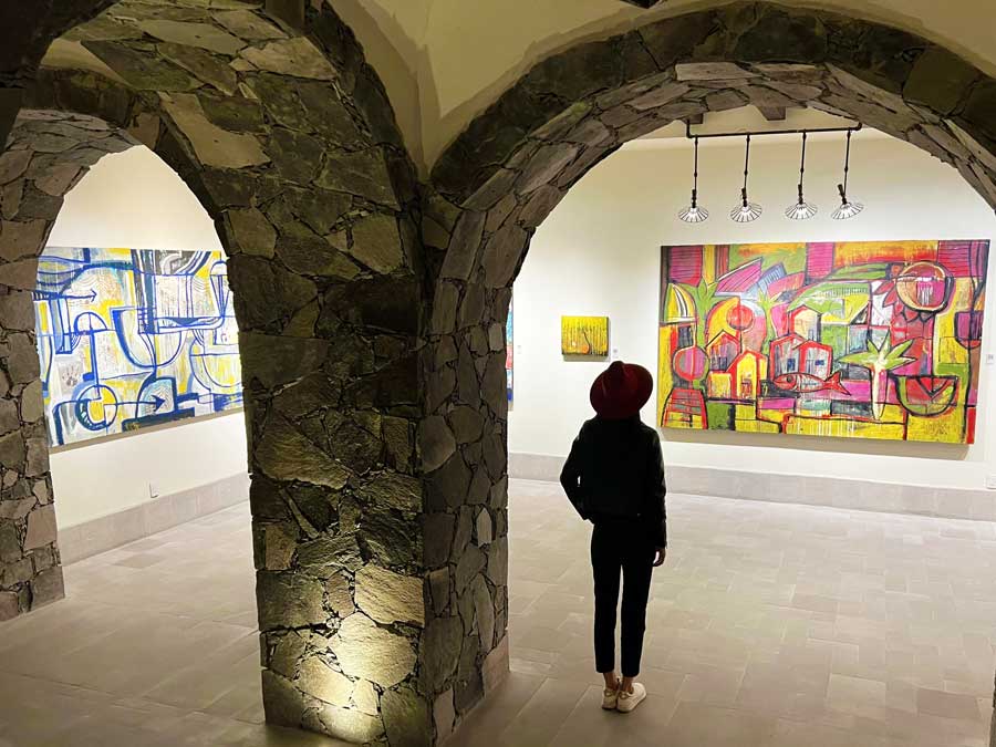 Clara admiring the paintings in The Rosewood