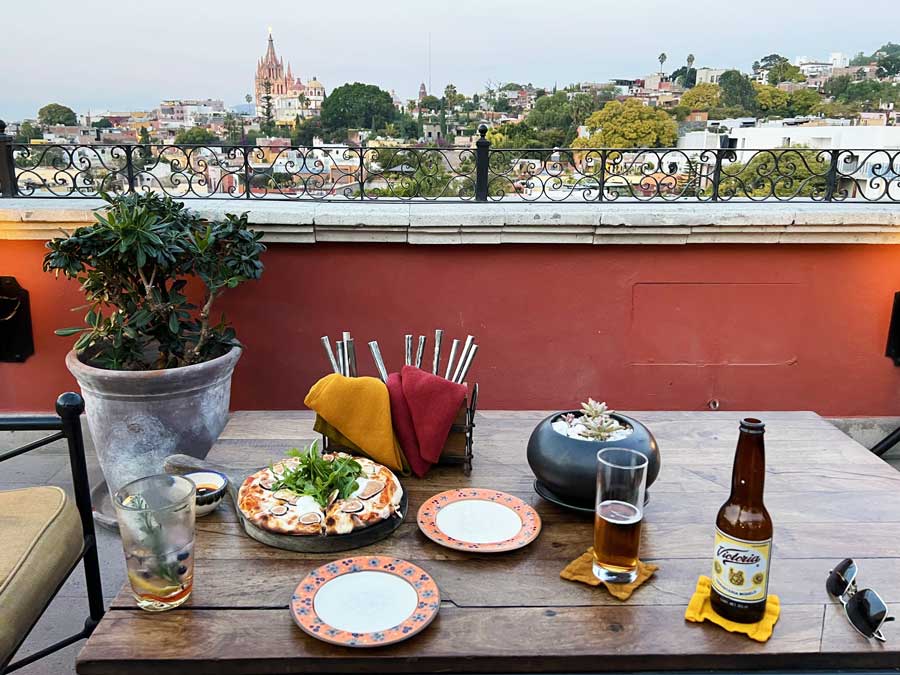 View drinks and foods on the table and the view from The Rosewood