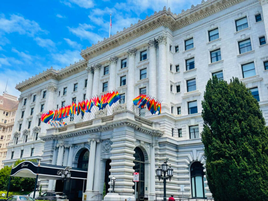 Entrance of San Francisco Fairmont with rainbow flags displayed during Pride month