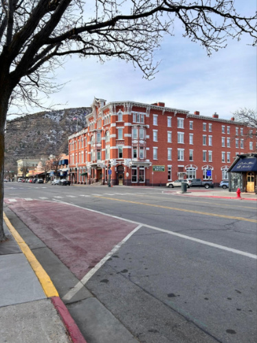 Exterior view of the Strater Hotel and other businesses on Main Avenue seen from across the street