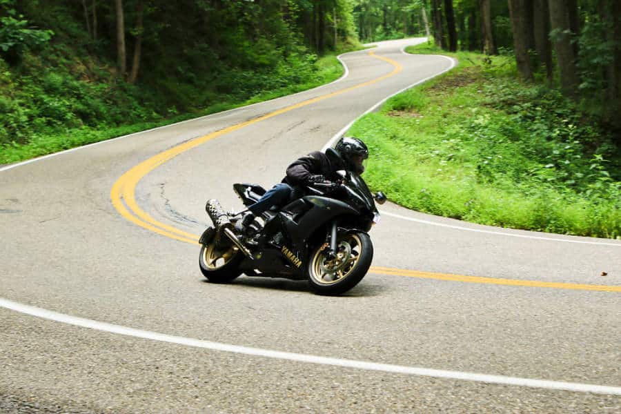 A motorcycle rider banking on the curves of The Tail of the Dragon at Deal's Gap