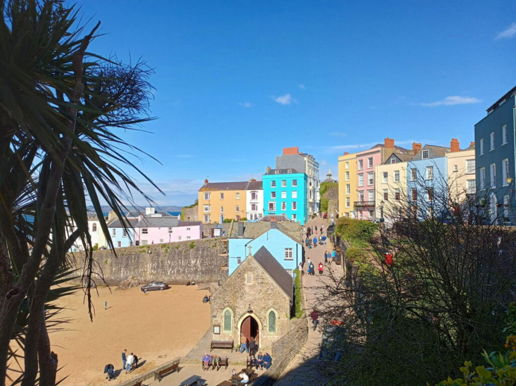 View of the Tenby North Beach and the nearby buildings, and people walking to the beach