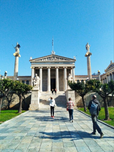 People walking in front of The University of Athens