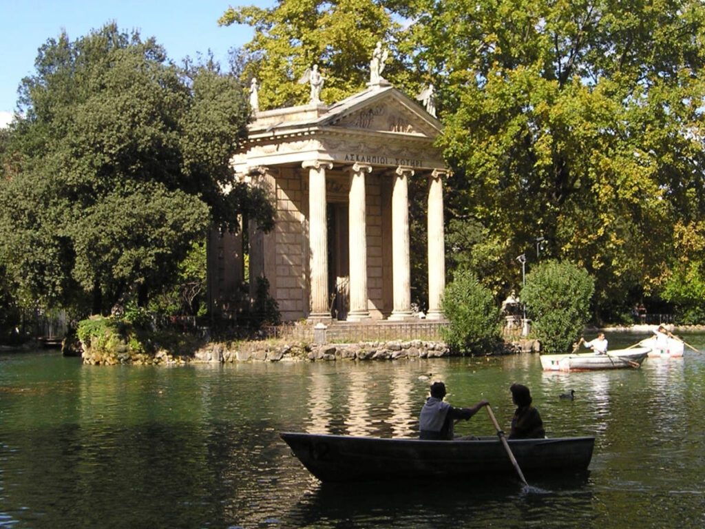 A couple paddles a boat on the tranquil lake at Villa Borghese