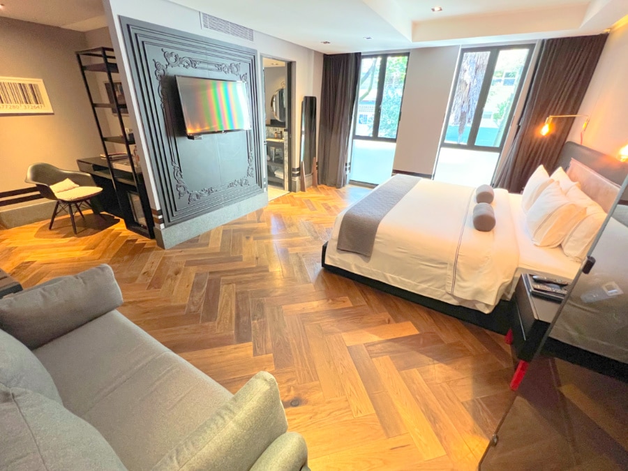 View of couch desk and bed at The Wild Oscar Polanco boutique hotel CDMX