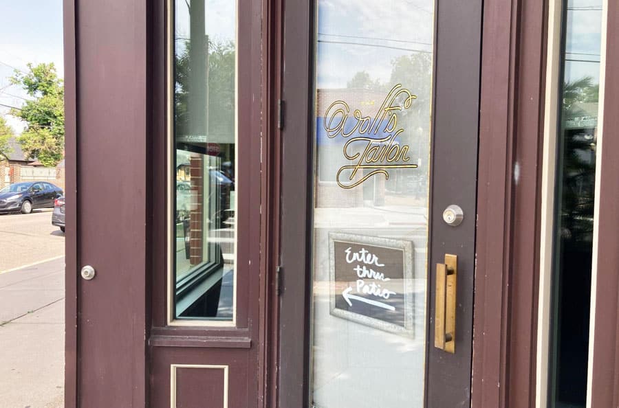A signage pointing the entrance to The Wolf’s Tailor
