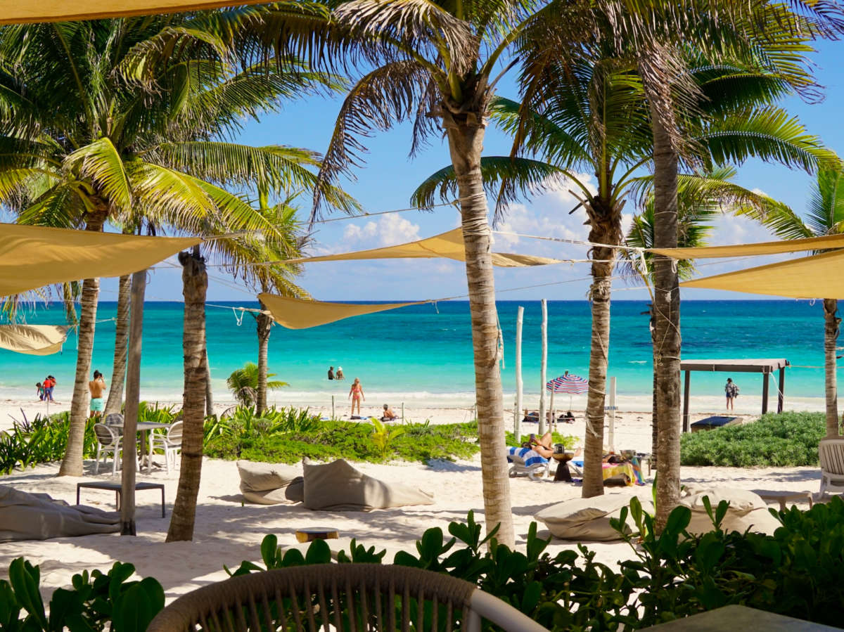 Turquoise waters of the Caribbean Sea wash up on the white sand beaches of the Xpu Ha seaside resorts