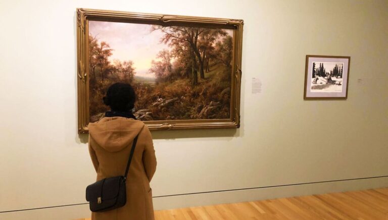 The author Chelsea Booker admiring a painting inside the Frye Art Museum