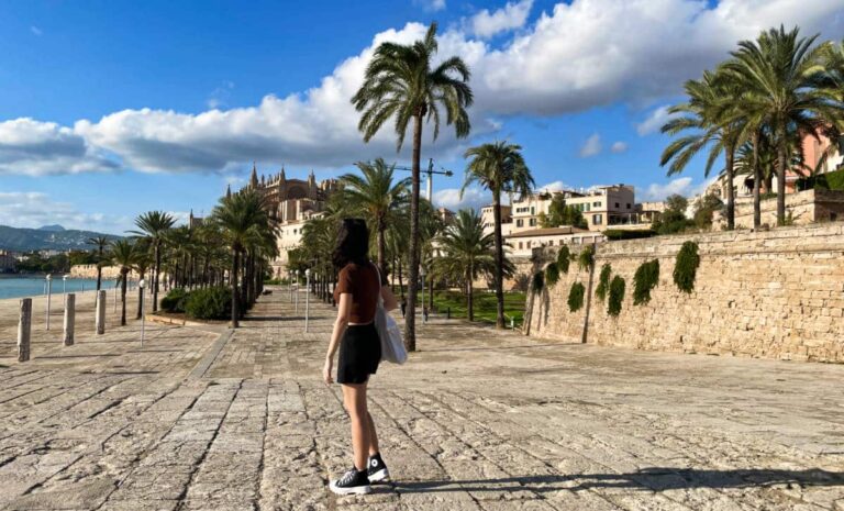 The author Lea Rose Allbaugh standing while facing the magnificent view in Palma de Mallorca