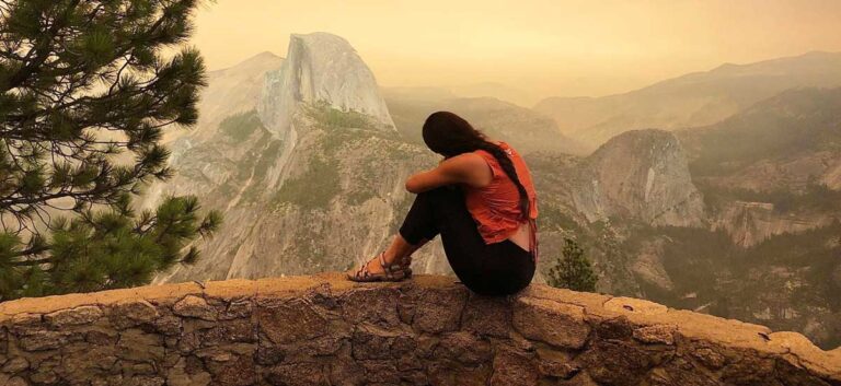 The author McKenna Mobley posing in front of the half dome of the Yosemite National Park