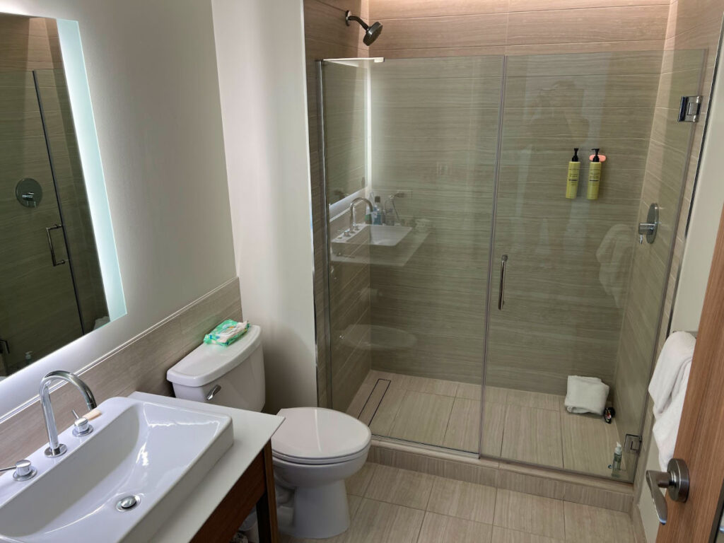 Modern bathroom with a toilet, sink, and shower at Element Denver Downtown East