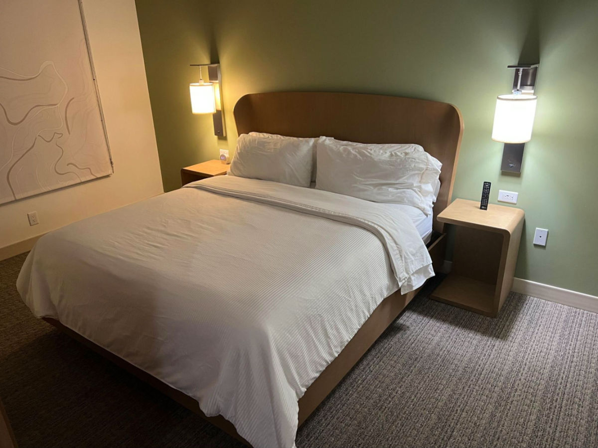 A room bed with white sheets and fluffy pillows at Element Denver Downtown East