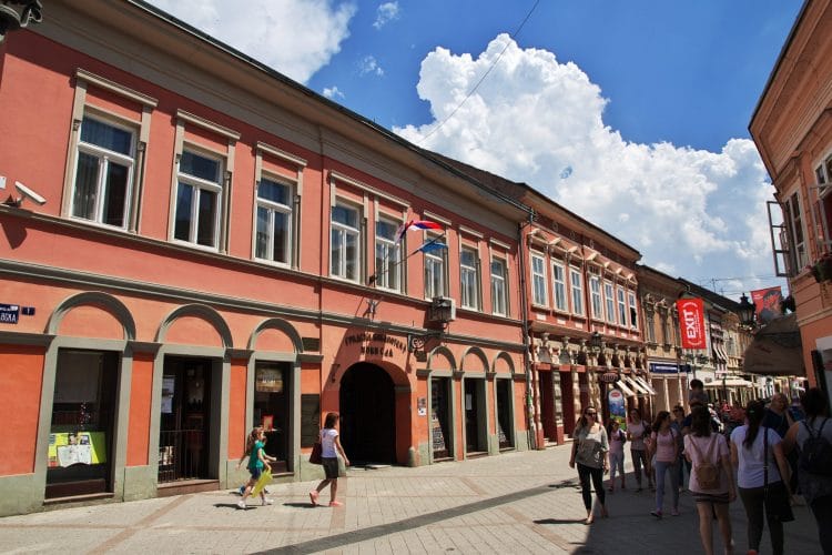 Street with many people and pink buildings