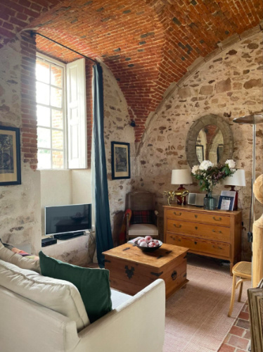 Cozy living room with brick wall at Château de Fleury