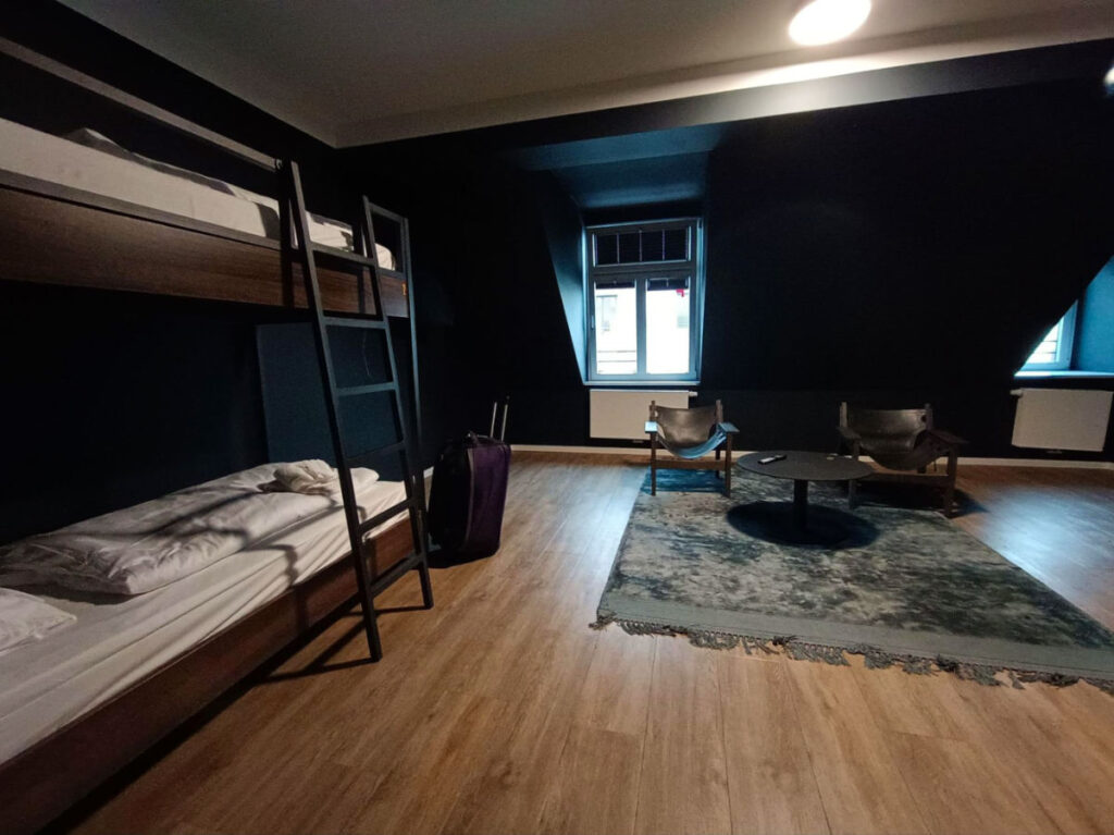 Interior of a dark room with bunk beds and a chair