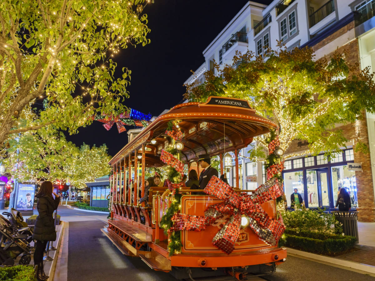 A trolley car adorned with Christmas decorations at The Americana