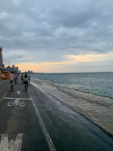 Author Niamh and friends biking on the waterfront bike lines with views of Lake Michigan