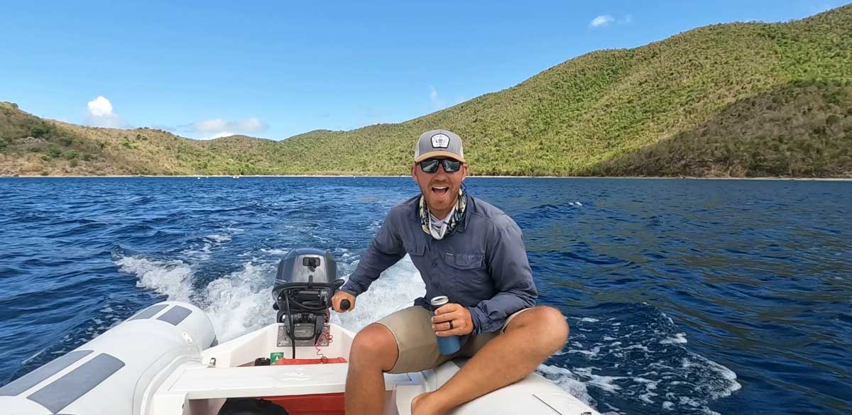 The author driving a boat at the St. John’s north shore