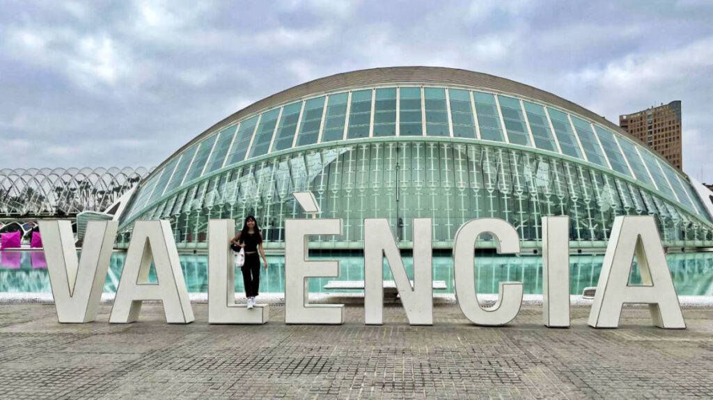 Travel Lemming Editor, Lea Rose Allbaugh, posing for a photo at the signage of VALENCIA, things to do in Valencia