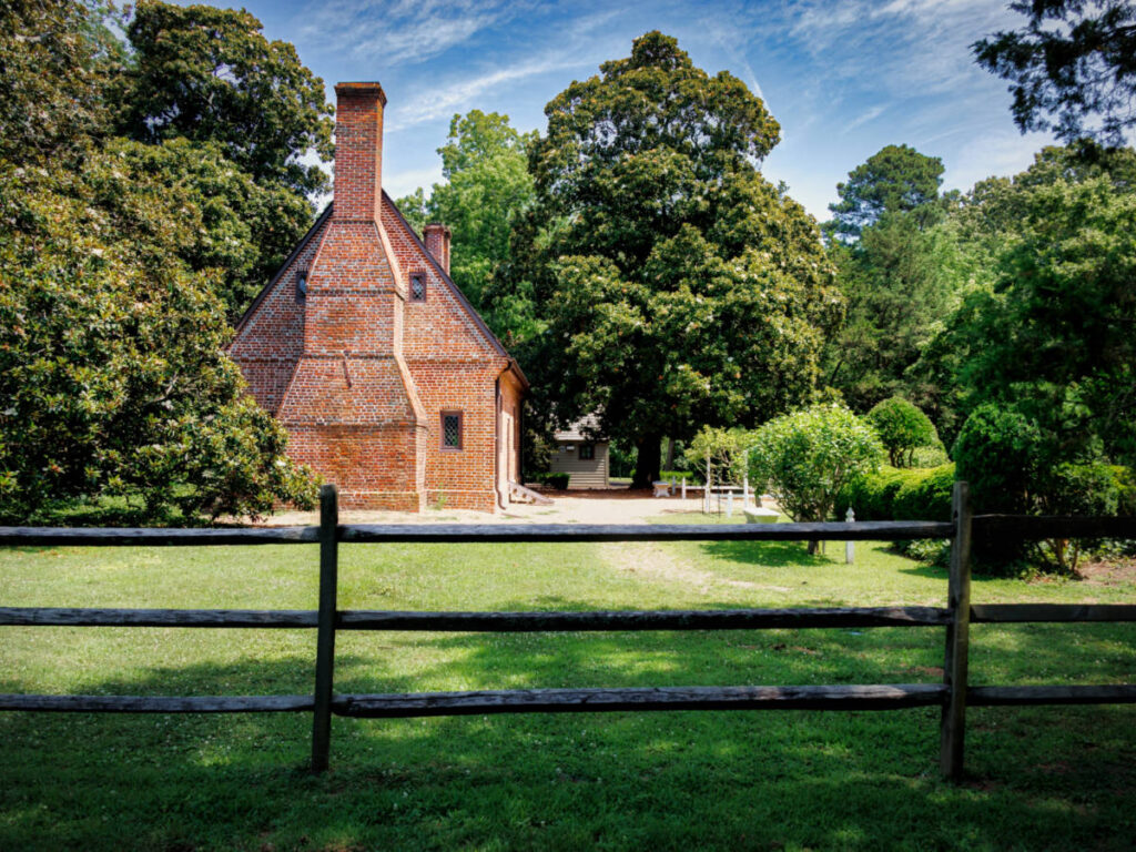 View of the colonial Adam Thoroughgood House surrounded by lush greeniries