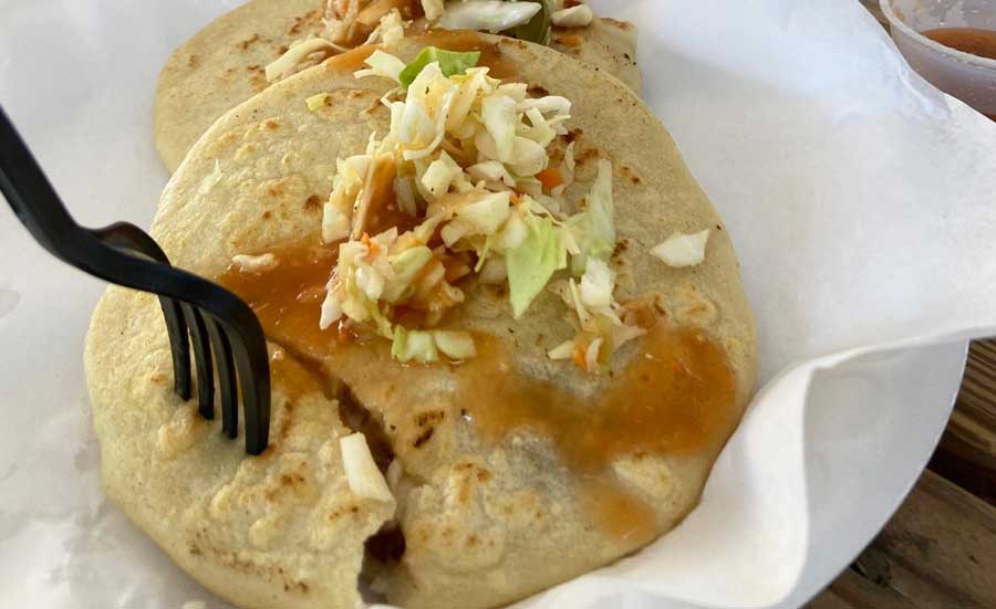 The author's food on a plate with a fork served in Three Weavers Brewing Company